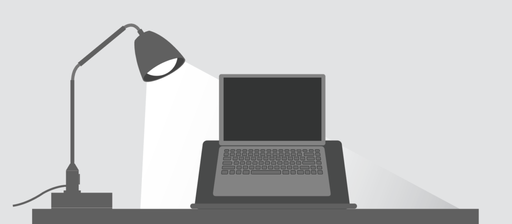 Illustration of a task light being used to illuminate a laptop sitting on a desk