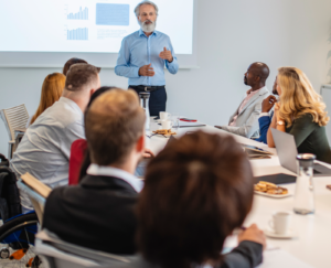 Photo of a person making a presentation to a group of workers