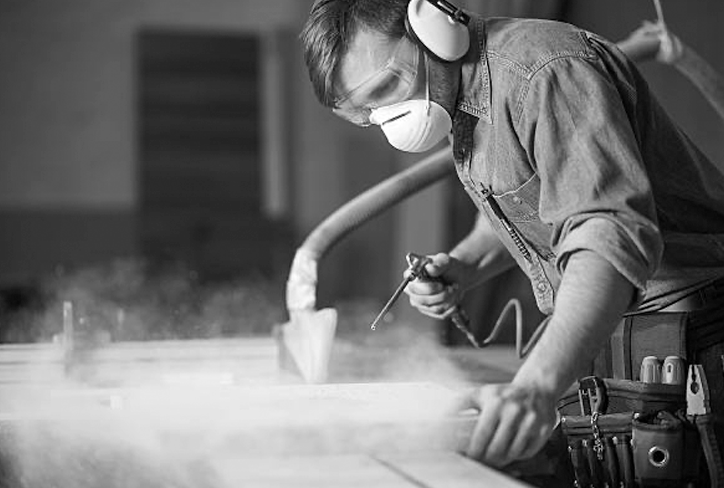 Photo of a worker in a noisy, dusty work environment