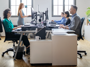 Business people at their desks in a busy, open plan office. Startup business people working at a modern office.