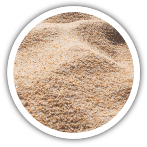 A photo/icon showing sand as a source of silica